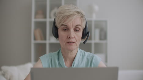 call-center-woman-is-answering-at-telephone-calling-in-tech-support-using-laptop-and-headphones-portrait-of-female-worker-indoors